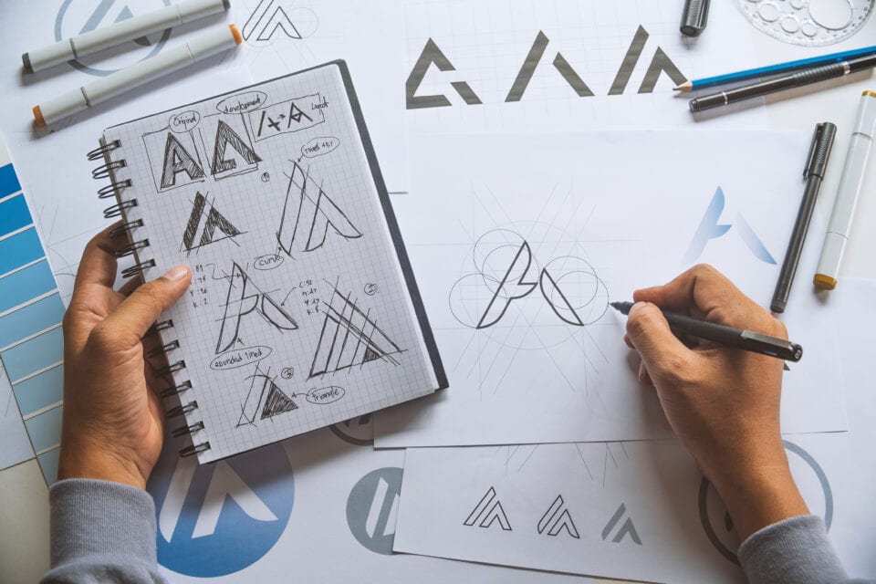 Graphic designer development process drawing sketch design creative Ideas draft Logo product trademark label brand artwork.